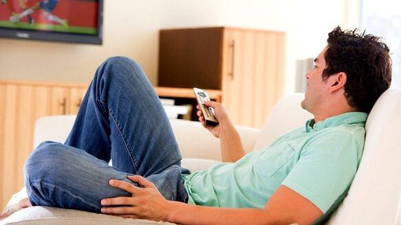 The man watches TV