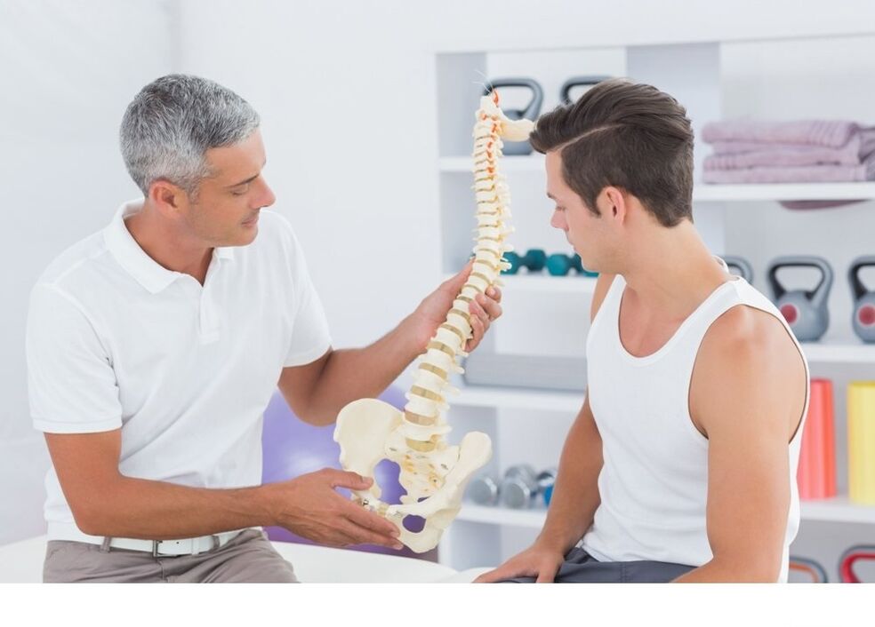 The doctor shows the patient the spine arthrosis